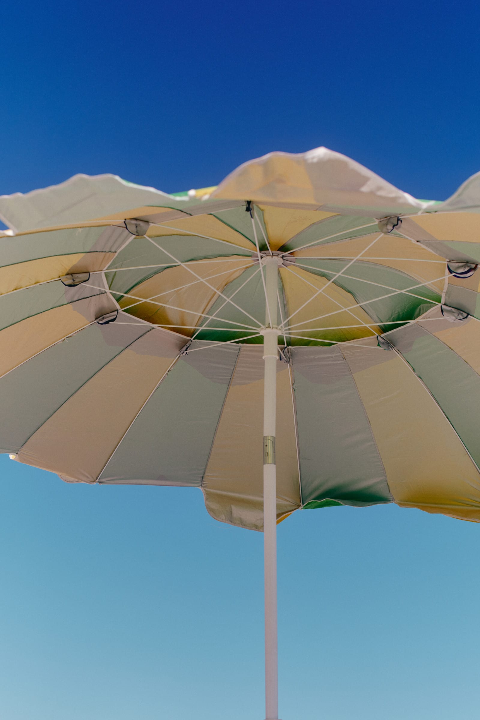 Beach umbrella seen from below against the sky